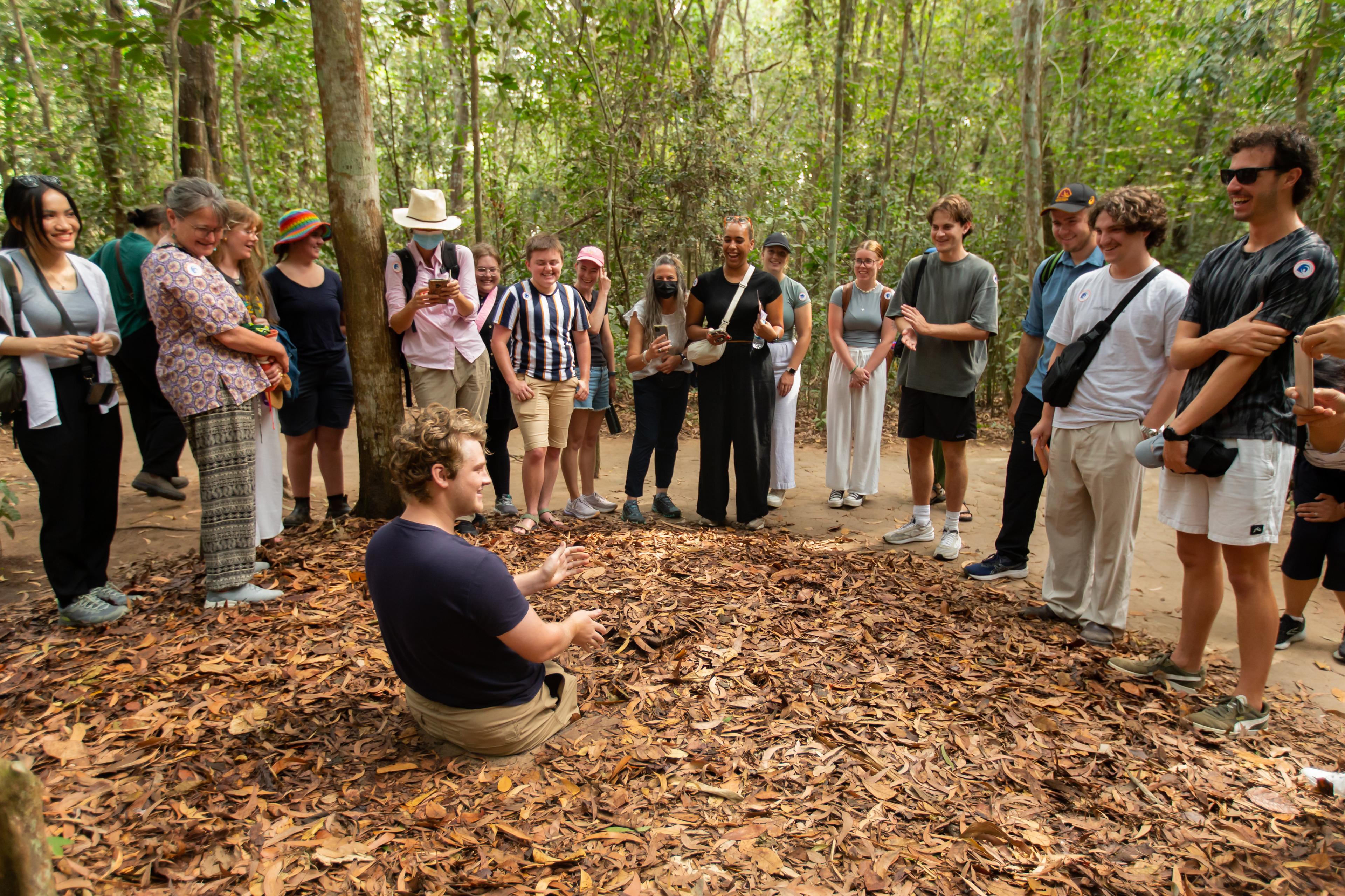 Travellers listening to a guide in the forest