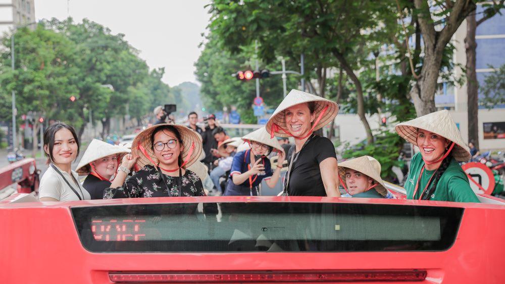 Travellers riding a city bus tour in Hanoi