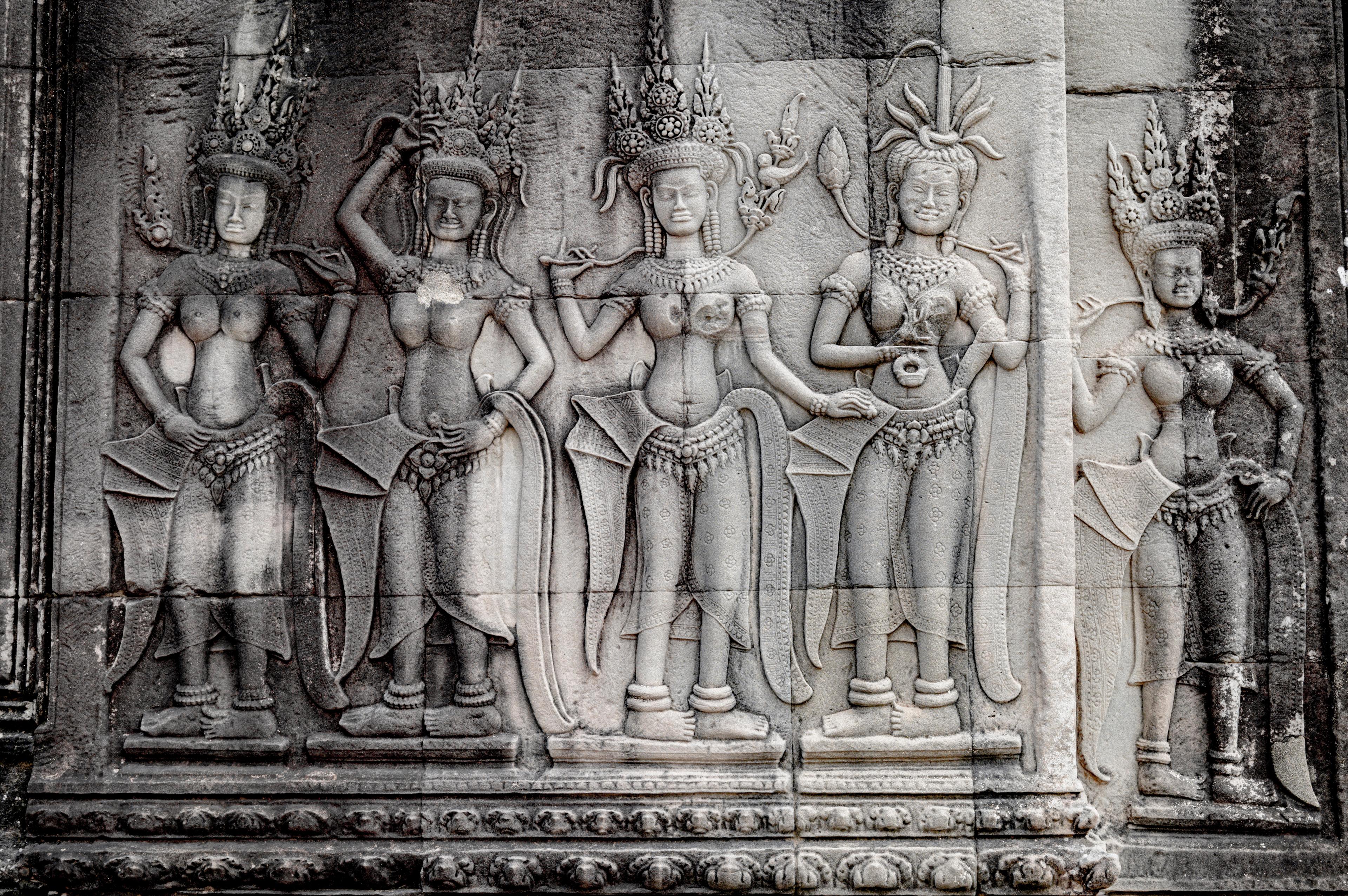 Apsara dancers carved in relief on a temple wall